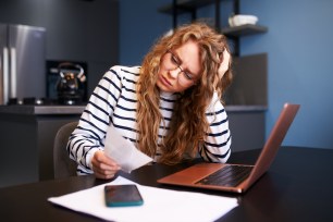 A woman researches how to stop living paycheck to paycheck.