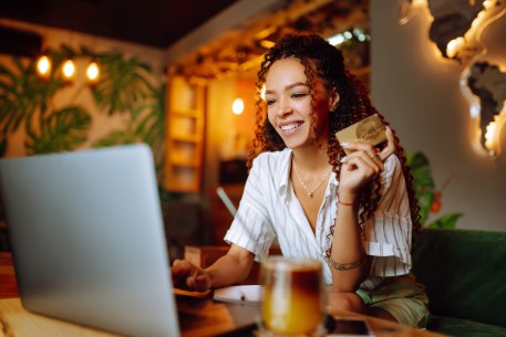 A young woman researches how to build credit fast with a credit card.